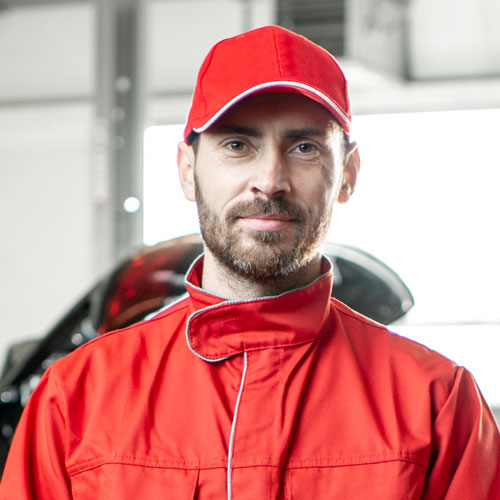 Clutch repair specialist in Southall providing detailed quotes for minor and full clutch repairs. Expert technician in a red uniform.